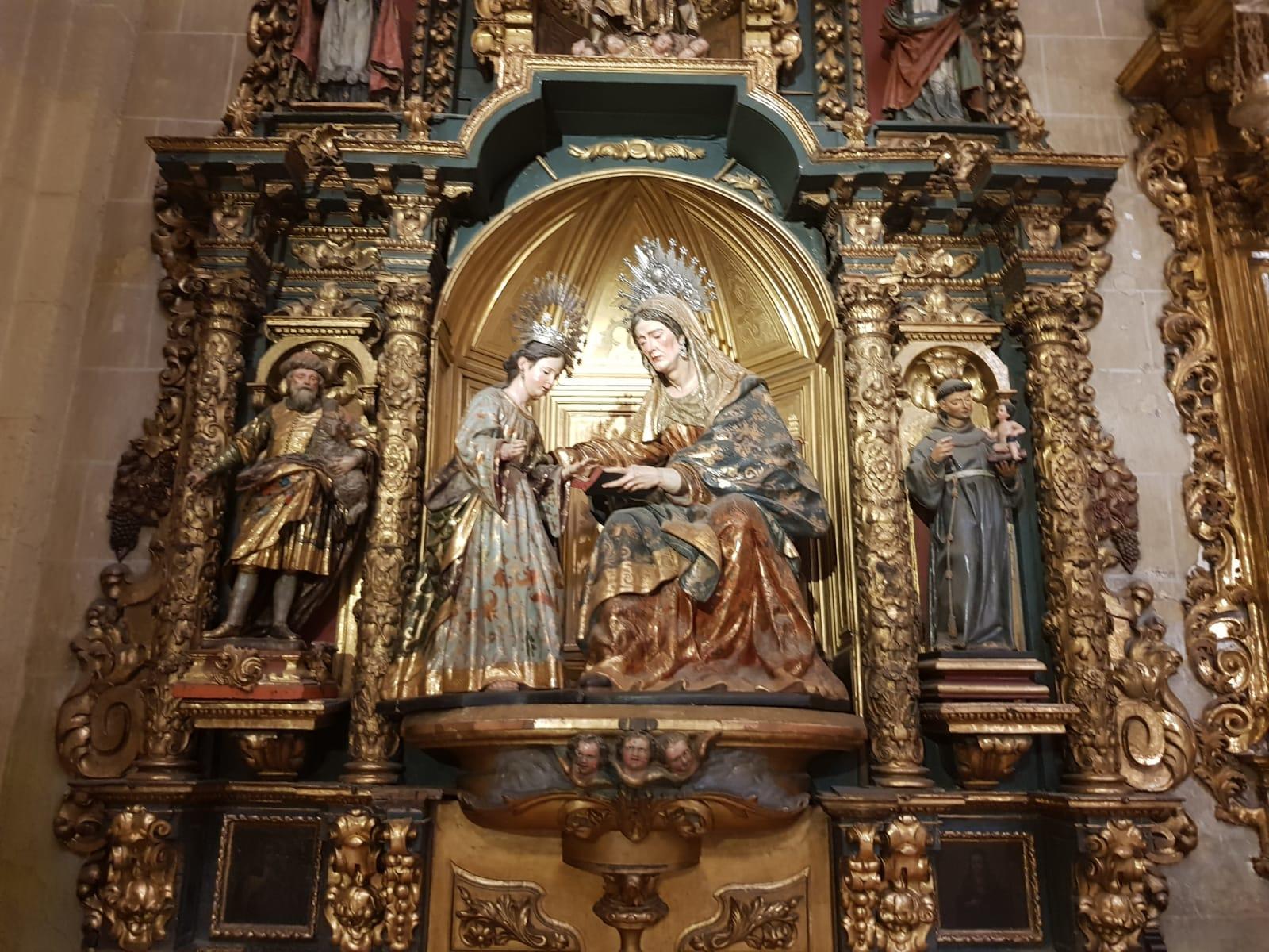 Ornate religious altar with detailed statues and gold accents.