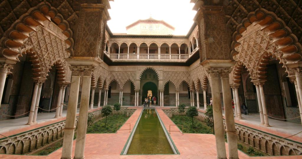 Ornate courtyard with central reflecting pool, arched columns, and intricate detailing.